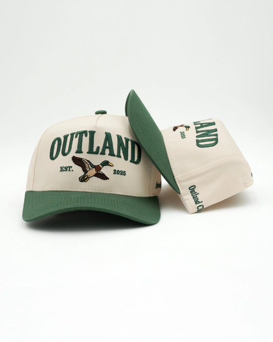 Two Outland caps with green and beige color scheme on a white background