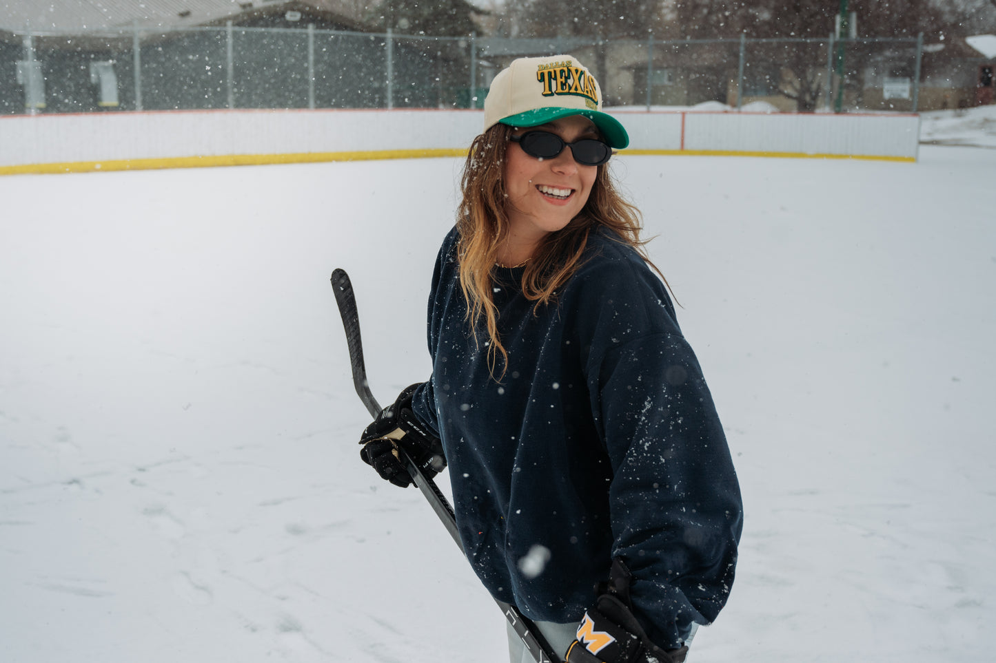 Outland Club Co. Dallas City Ice Classic Snapback Hat close portrait, green brim Texas hockey snapback worn with hockey equipment at outdoor rink
