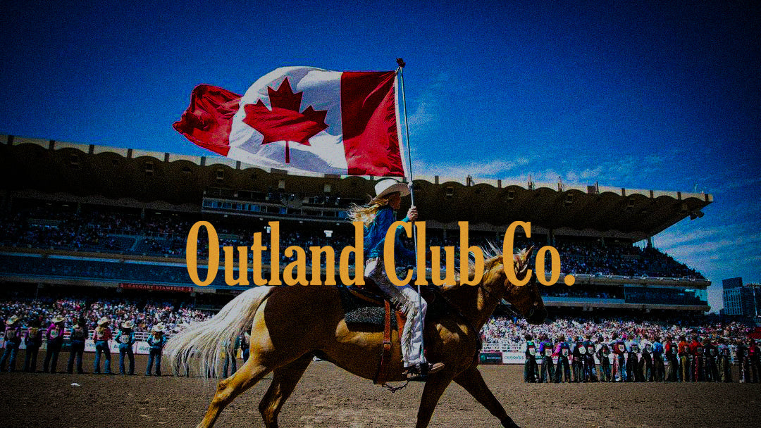 Person riding a horse with a Canadian flag at a stadium event.
